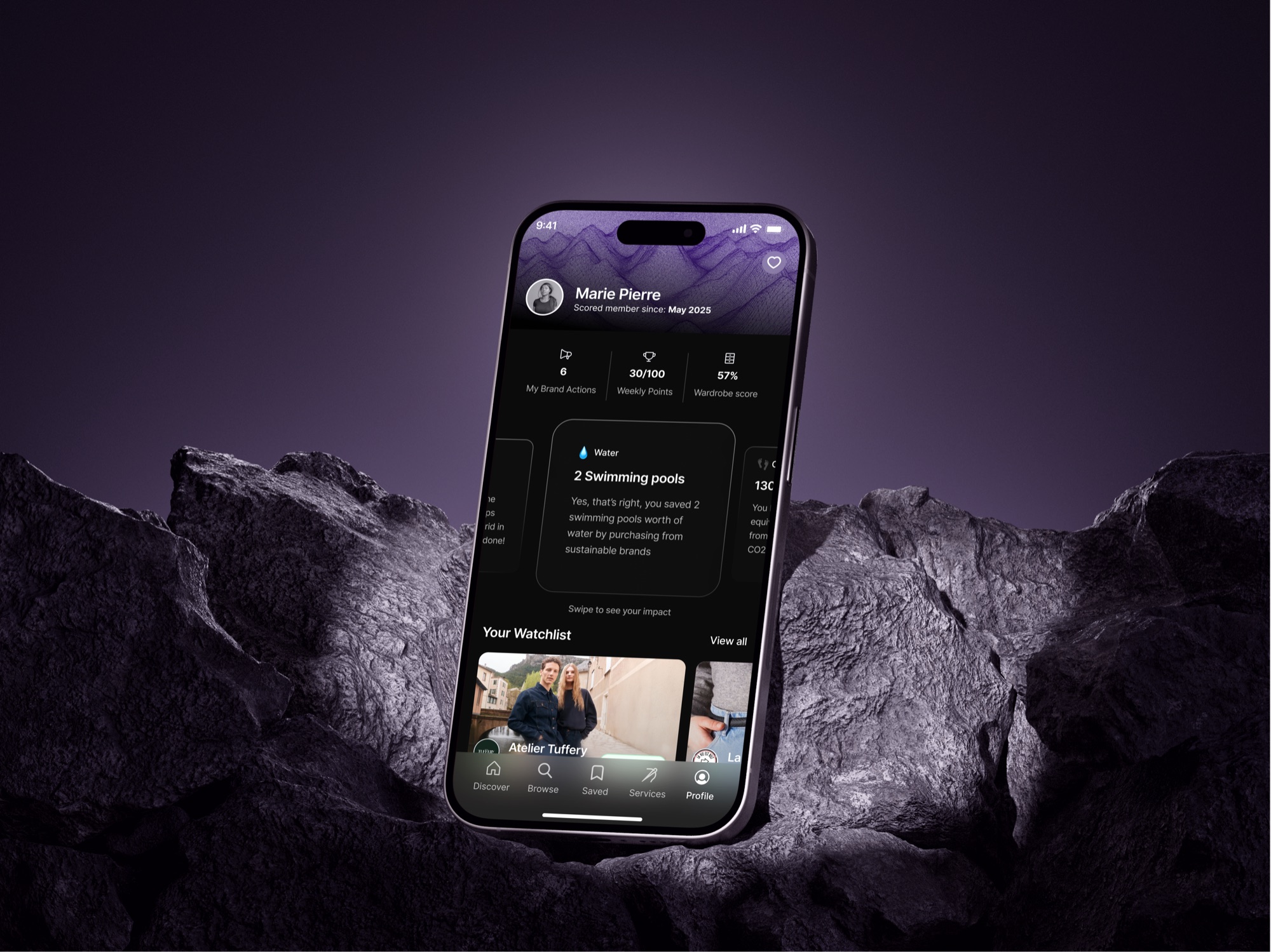 Scored app user profile screen with sustainability score, phone mockup on rock